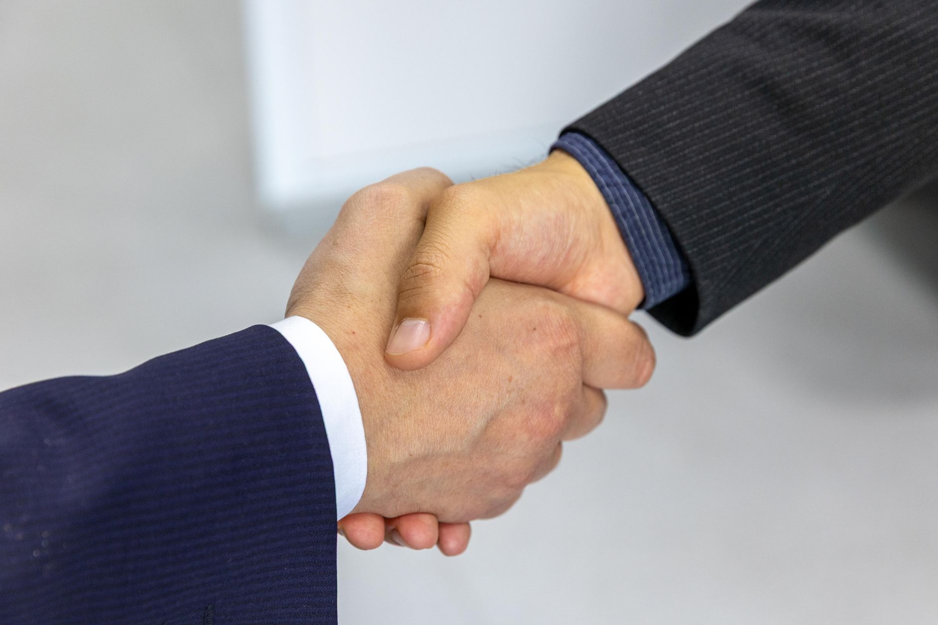 Two businessmen shaking hands, symbolizing agreement and partnership.